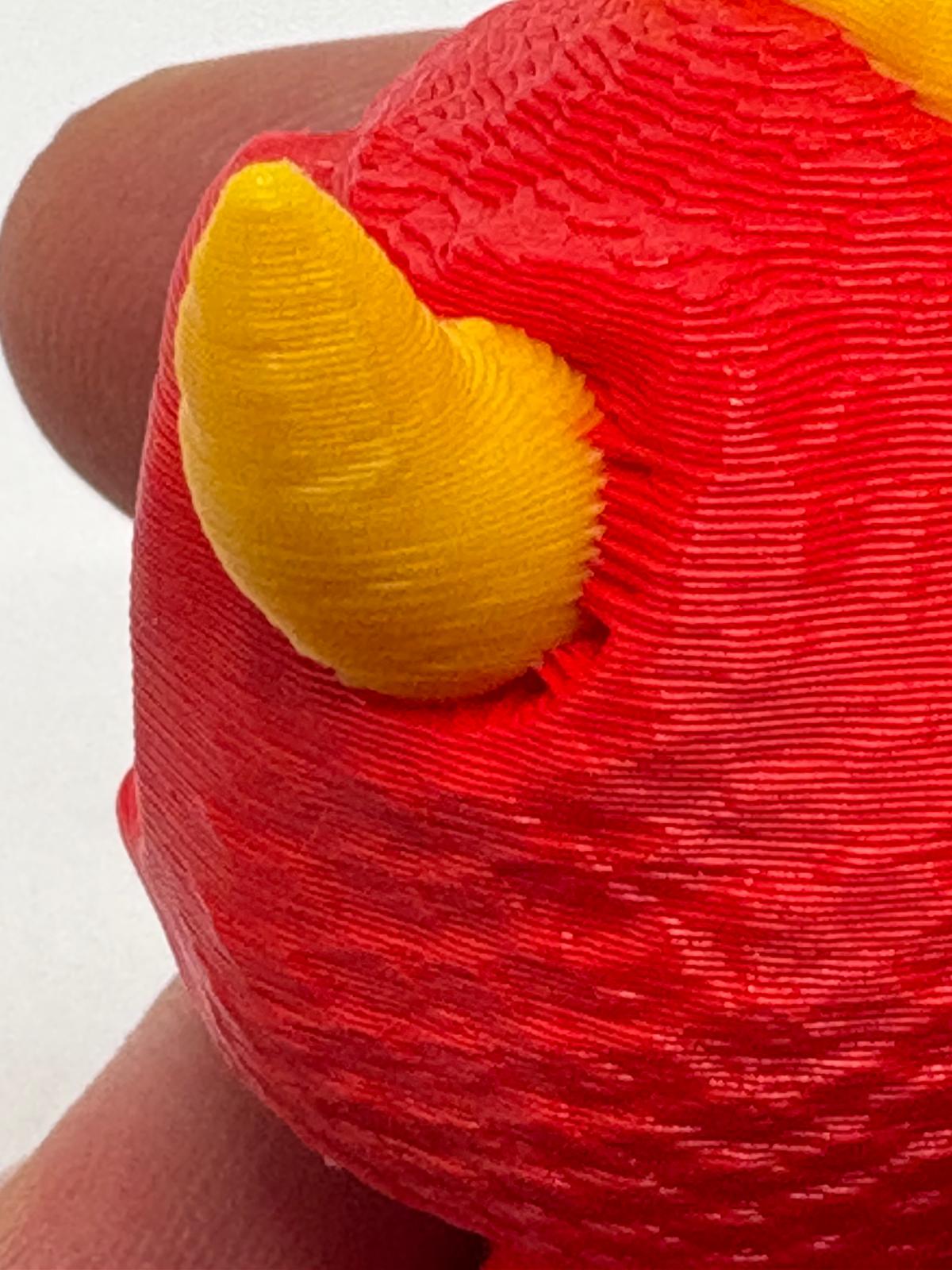 Close view before adjustment showing an uneven joint where the yellow horn meets the red head